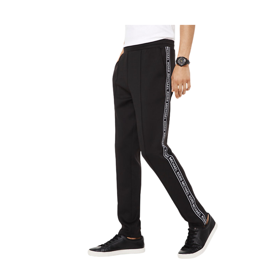 Black jogger pants with white stripes on a white background