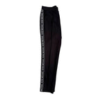 Black pants with 'Michael Kors' branding on a white background