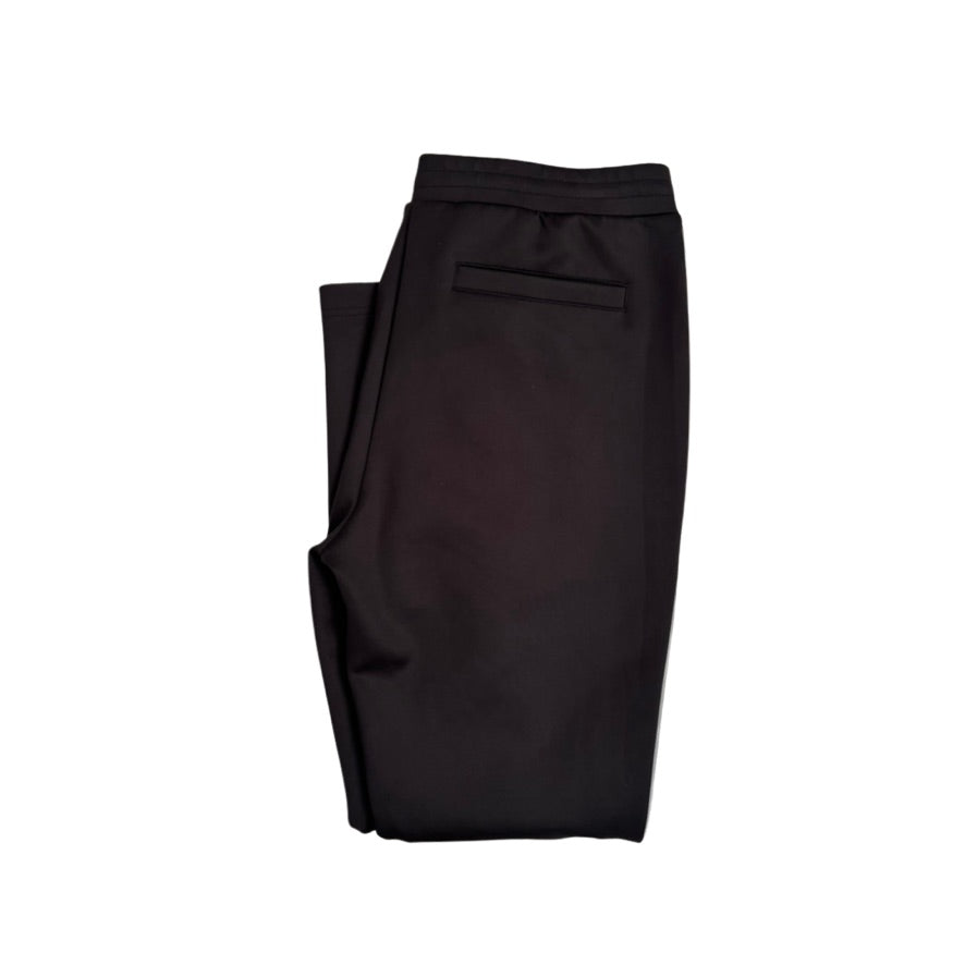 Folded black pants on a white background