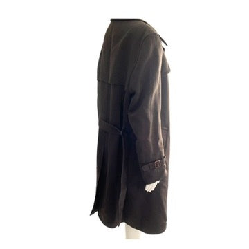 Dark coat on a mannequin against a white background