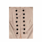 Close-up of a pale pink jacket  with black buttons on a white background