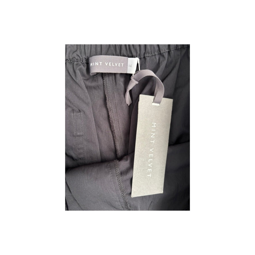 Black pants with a Mint Velvet tag on a white background