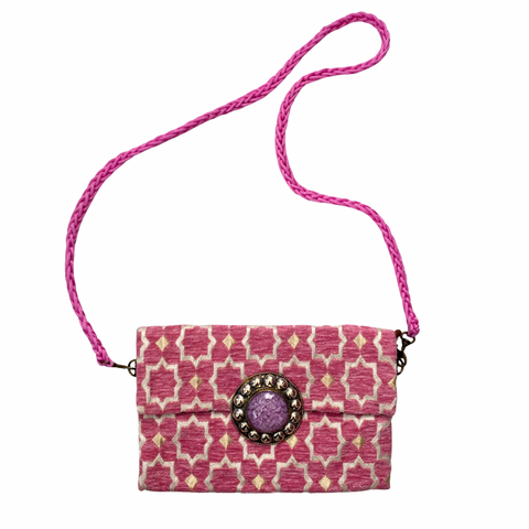 Moroccan-inspired pink patterned shoulder bag with lilac stone embellishment and braided strap. 