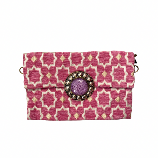Pink patterned clutch with a decorative button on a white background