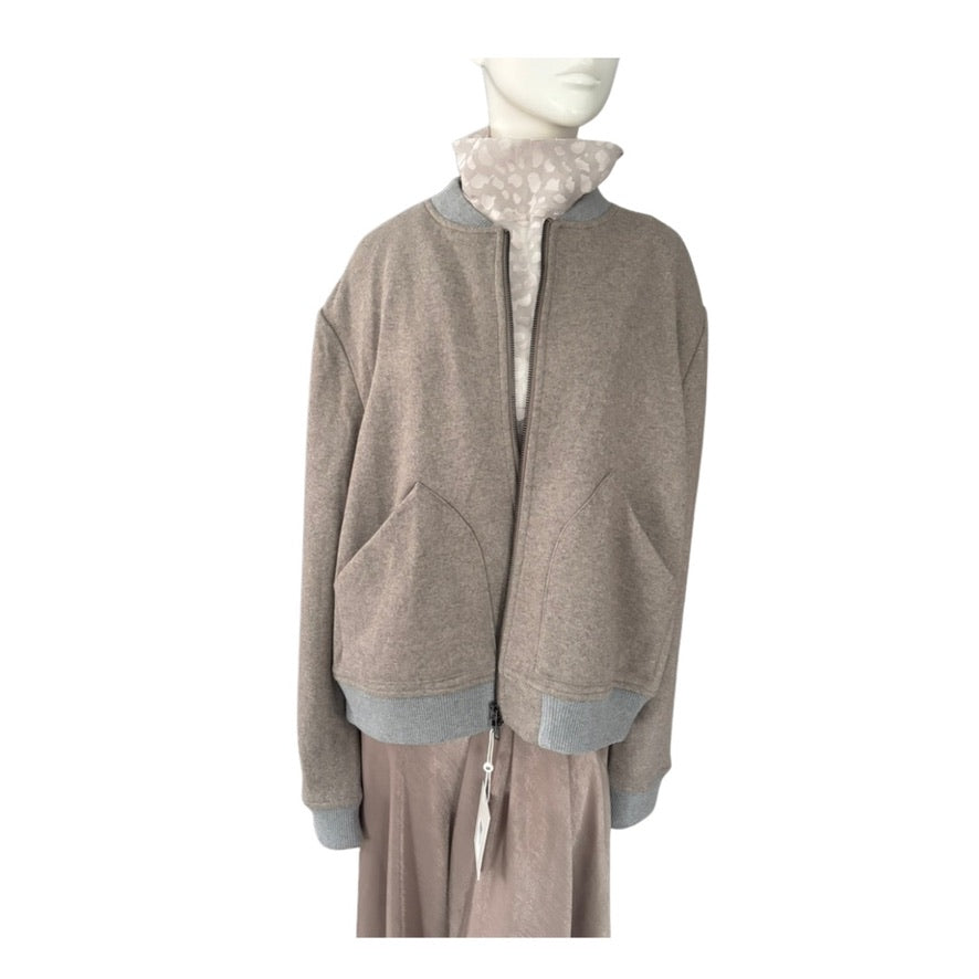 Mannequin wearing a beige jacket with a white shirt underneath on a white background