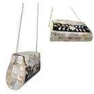 Two handbags with shell-like patterns on a white background