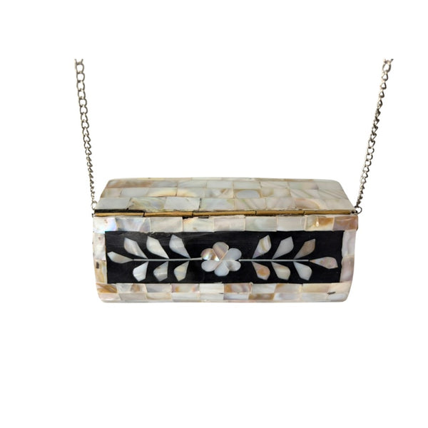 Decorative box with floral patterns and a chain on a white background
