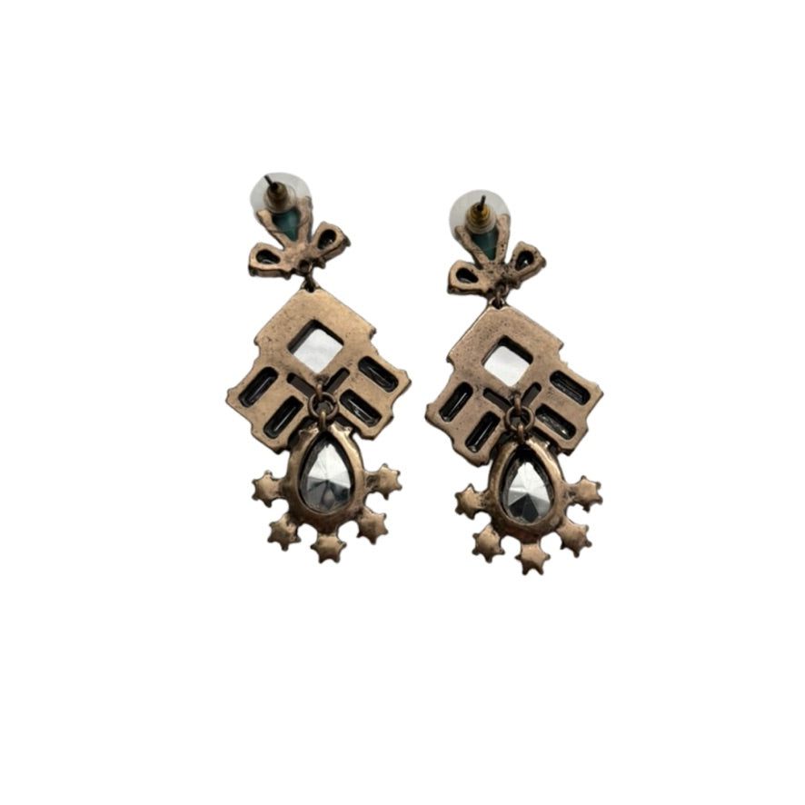 Pair of ornate earrings on a white background