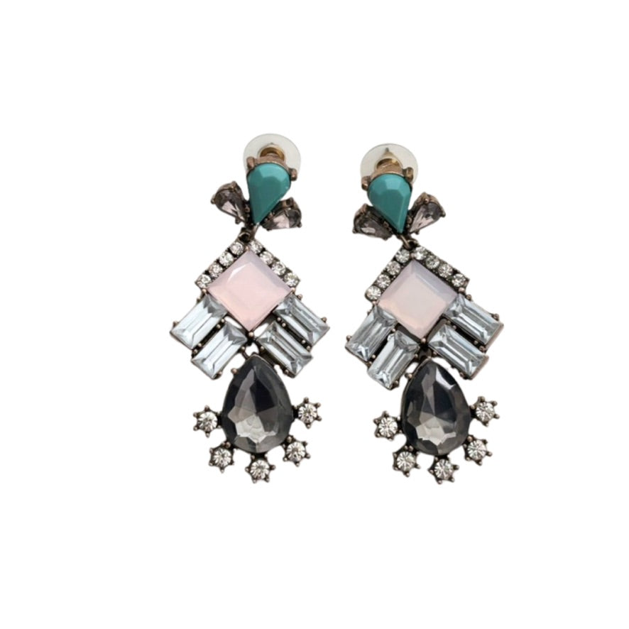 Pair of earrings with colorful gemstones on a white background