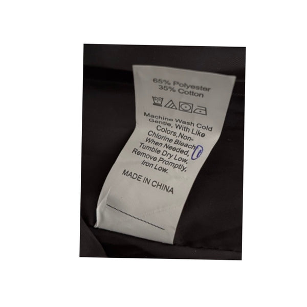 Clothing label with washing instructions on a black fabric background