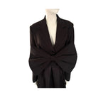 Black blazer with a large bow on a mannequin against a white background