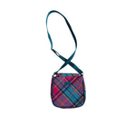 Plaid patterned bag with a strap on a white background