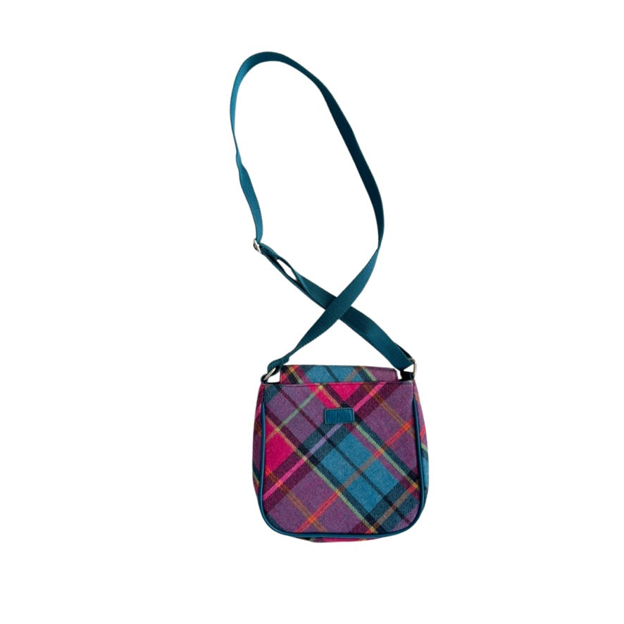 Plaid patterned bag with a strap on a white background