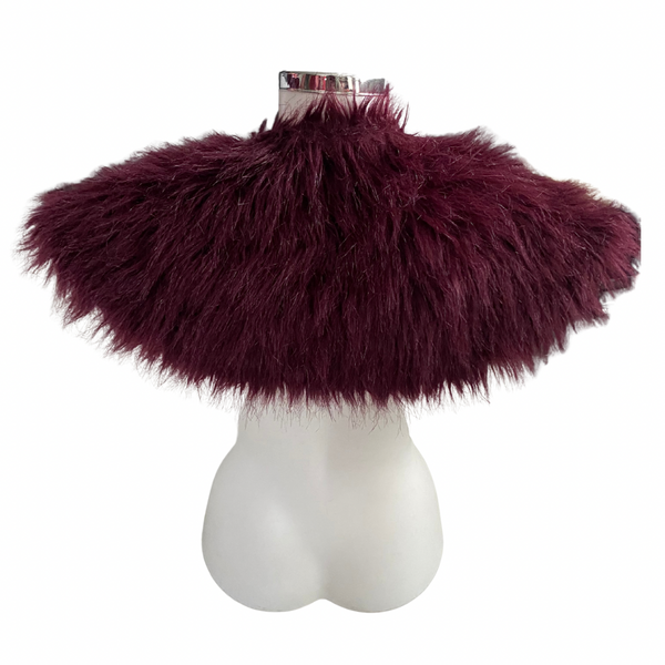 Burgundy fluffy shawl on a mannequin bust against a white background