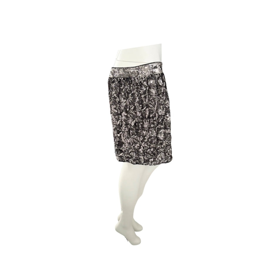 Black patterned skirt on a white mannequin against a white background