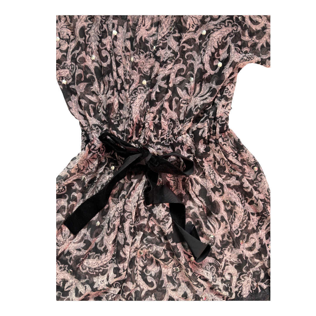 Patterned dress with a black ribbon on a white background