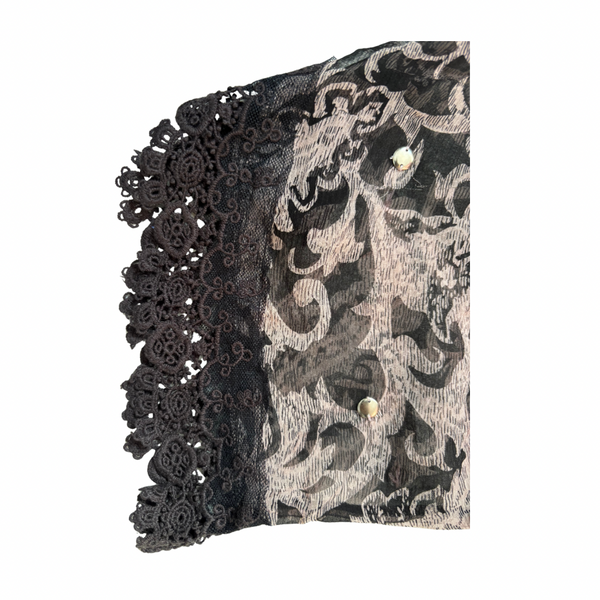 Black lace trim on a patterned fabric background