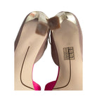 Close-up of high-heeled shoes with visible brand logo on a white background