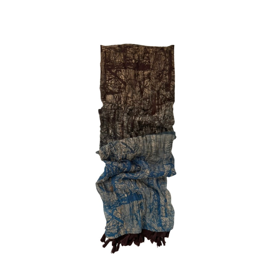 Patternedscarf with a mix of brown and blue colors on a white background.