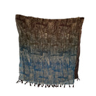 Patterned scarf with brown and blue pattern on a white background