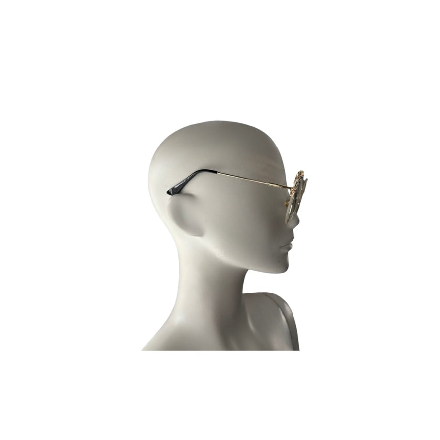 Mannequin head wearing a pair of sunglasses on a white background