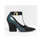 Teal and black high-heeled shoe with a gold buckle on a white background
