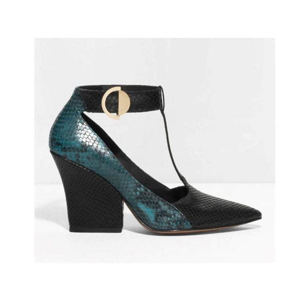Teal and black high-heeled shoe with a gold buckle on a white background
