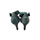 Pair of snake skin patterned boots on a white background