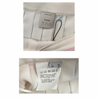 Close-up of a Pinko label on a garment with additional text and symbols.