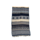 Striped patterned blanket with fringes on a white background