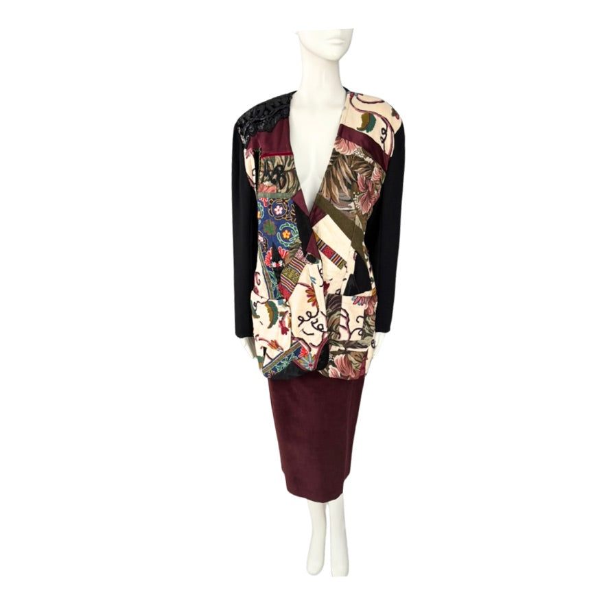 Mannequin wearing a colorful patchwork blazer and maroon skirt on a white background
