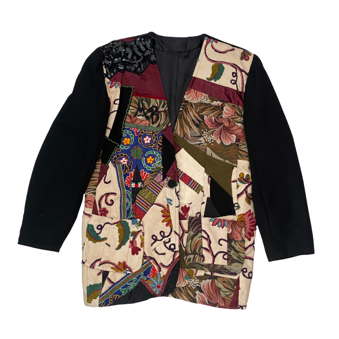 Colorful patchwork jacket with black sleeves on a white background