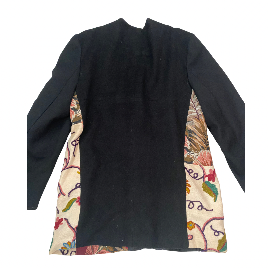 Black jacket back with colorful patchwork panels  on a white background
