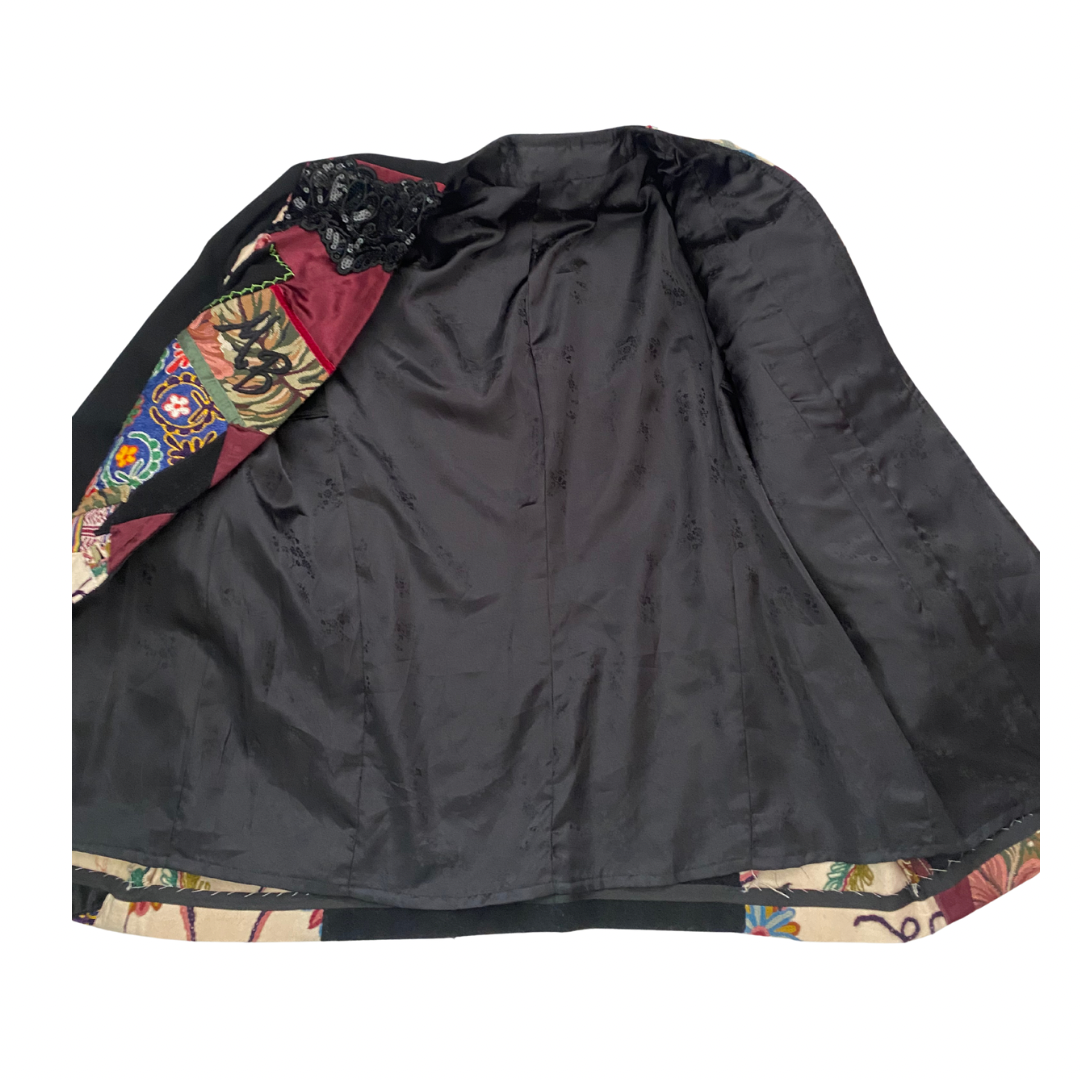 Patchwork jacket showing black lining   on a white background