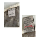 Textile label with brand name and care instructions on a textured fabric background