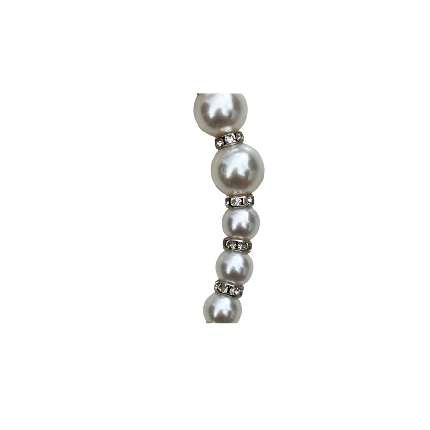 Pearl earring with rhinestones on a white background