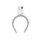 Silver beaded hairband with a pink and white patterned card on a white background