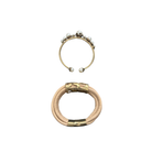 Two gold bracelets with pearl accents on a white background