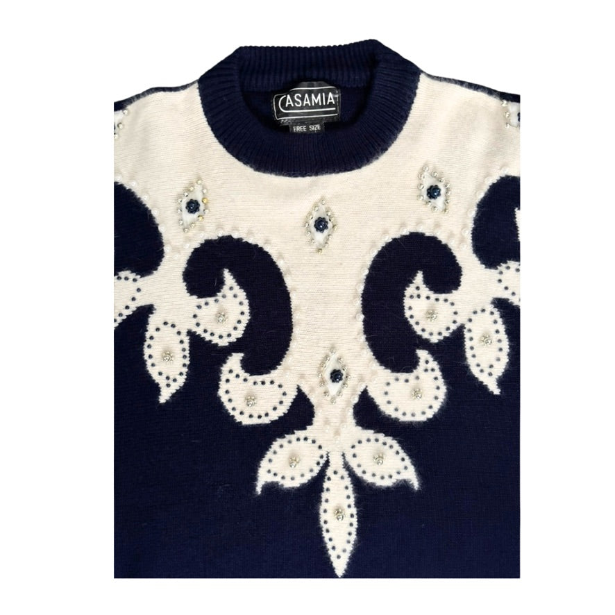 Navy and white patterned sweater with 'Casamia' branding on a white background