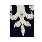 Close-up of a decorative fabric pattern with black and white colors on a white background