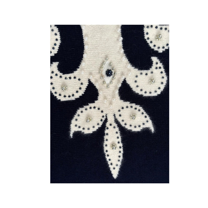 Close-up of a decorative fabric pattern with black and white colors on a white background