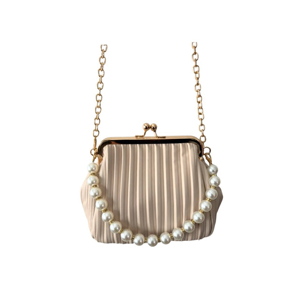 Beige handbag with pearl embellishments on a white background