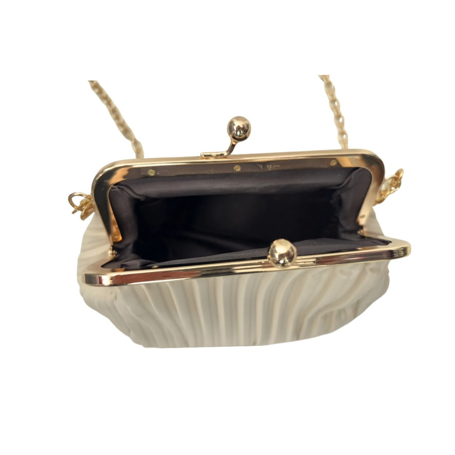 White handbag with gold frame and handle on a white background