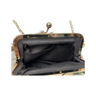 Close-up of a black handbag with gold frame and chain handle on a white background