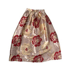 Floral patterned skirt with red and gold colors on a white background
