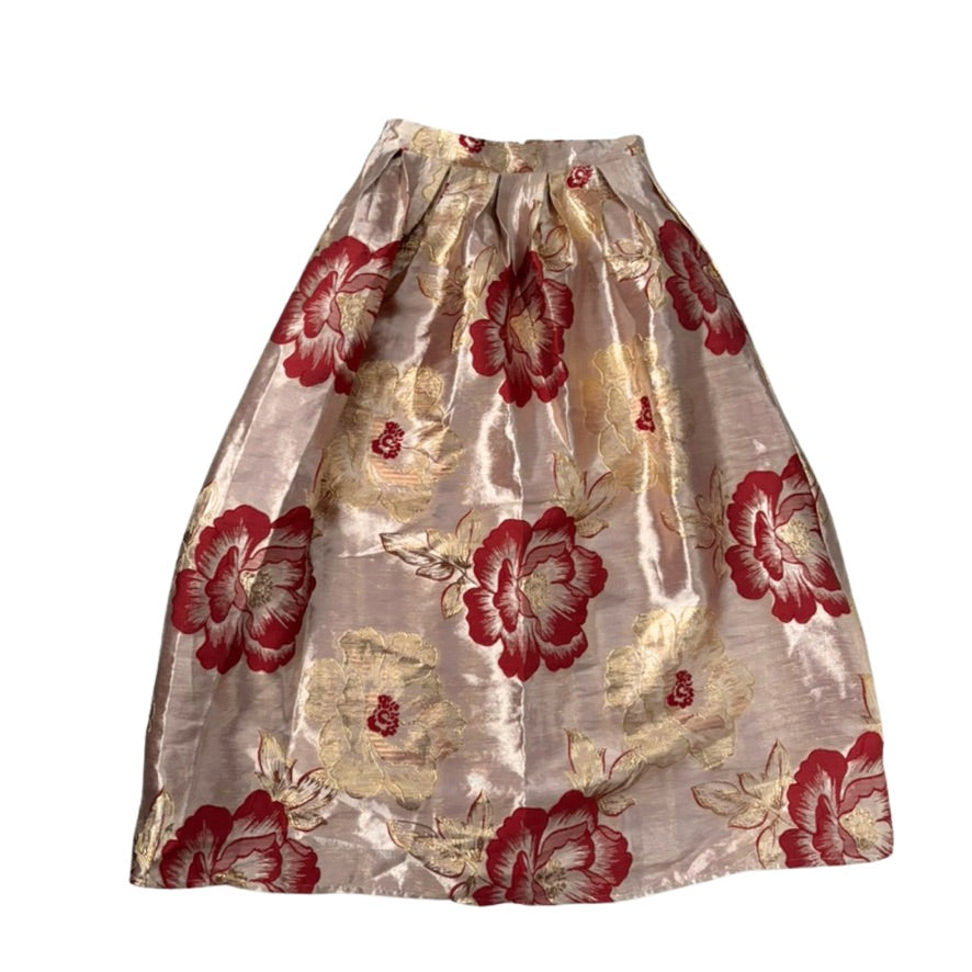 Floral patterned skirt with red and gold colors on a white background