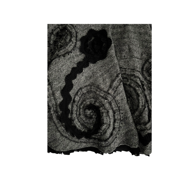 Black and grey patterned fabric with a central design