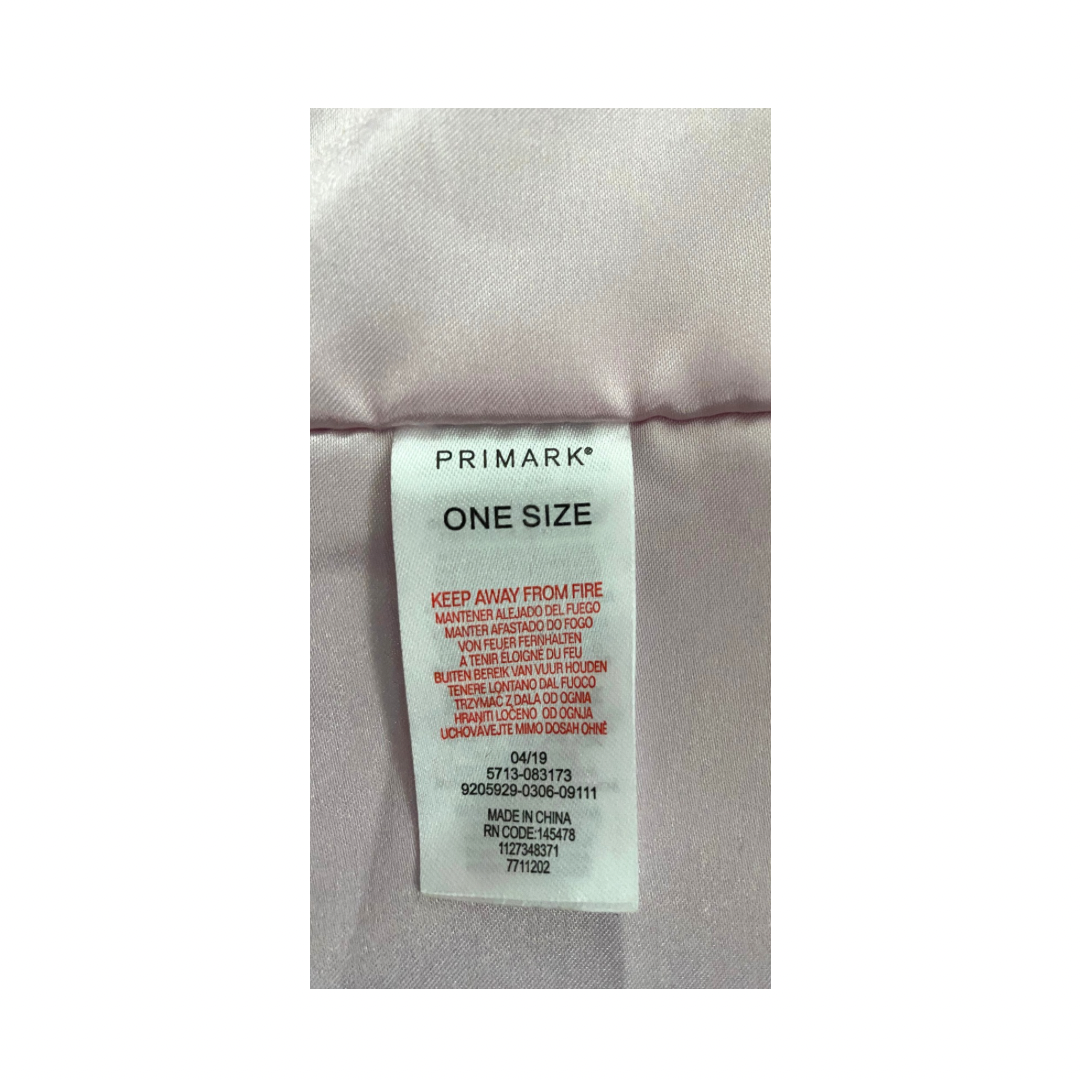 Close-up of a Primark label on a garment with text and product details.