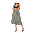 Woman wearing a black and white striped dress on a white background