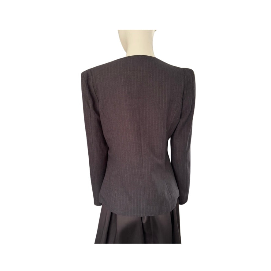 Dark gray suit jacket on a mannequin against a white background